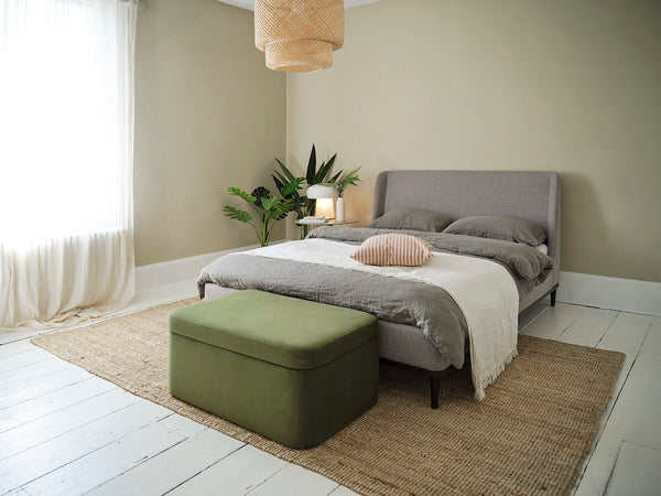 green storage ottoman with grey bed