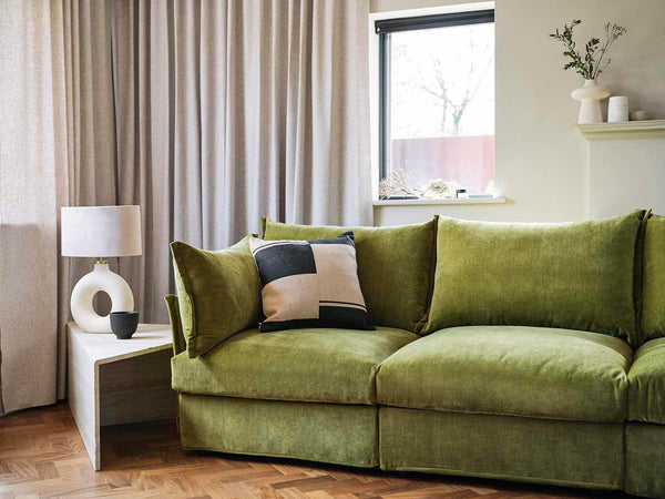 Green sofa with side table