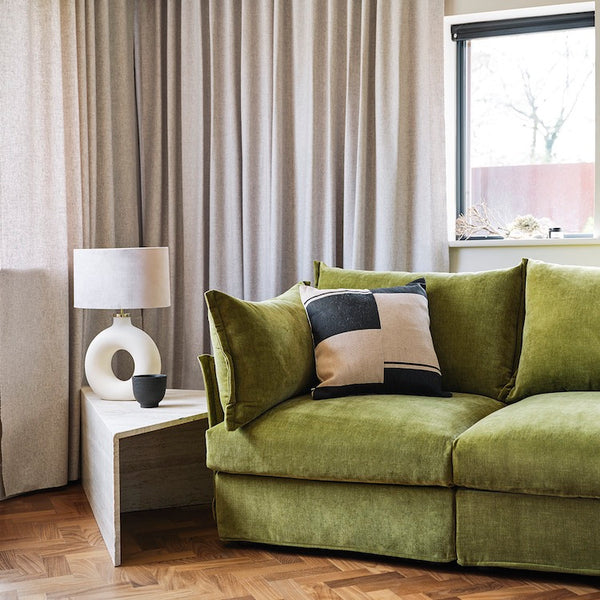 green sofa in neutral colour room