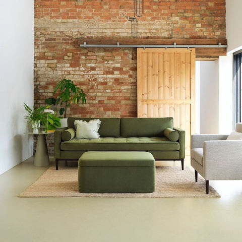 green sofa brick wall brick wall living room exposed brick wall living room green side table sage green side table green ottoman sliding door barn door