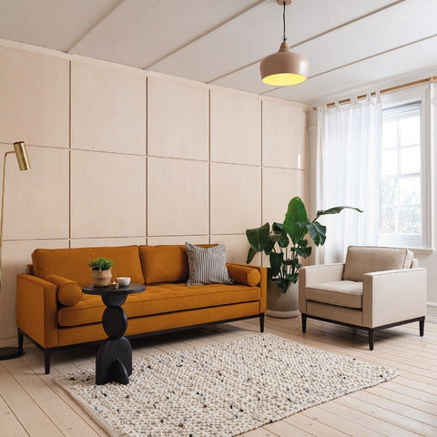 scandi style living room scandinavian living room decor faux suede sofa suede sofa yellow sofa brown sofa wool armchair wool upholstered chair birch panelling wood wall panelling living room panelling pendant light shade