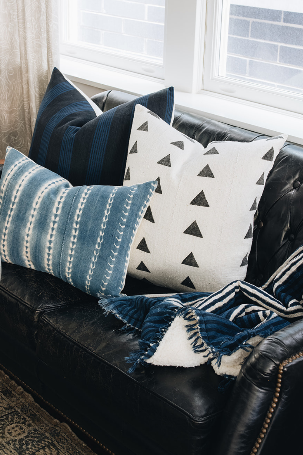 how to effortlessly style a throw blanket on the corner of a sofa