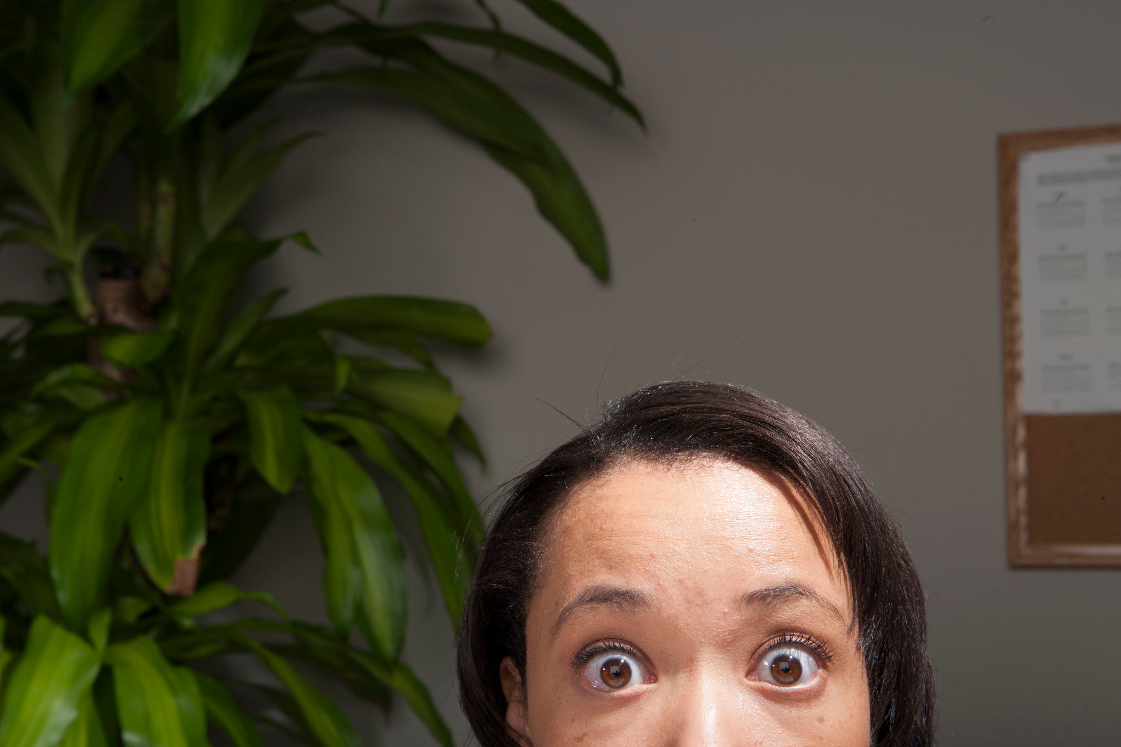 A surprised professional looking up into camera.