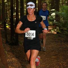 Shiwon & David running through the woods as part of a race