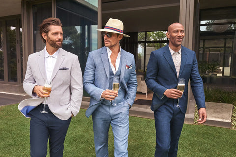 men dressed on suits attending a summer wedding