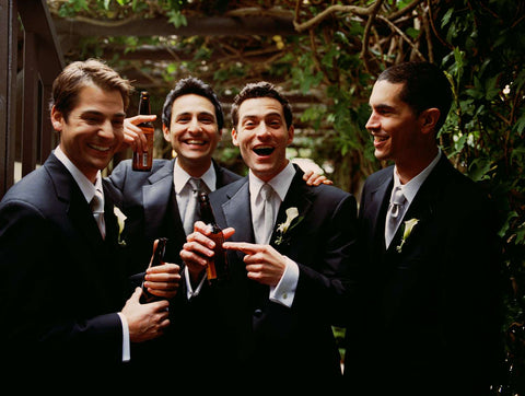 men laughing together at a wedding
