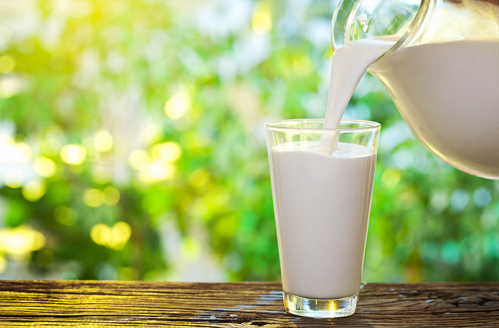 milk being poured into a glass