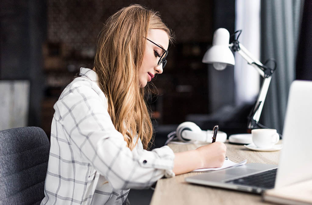 woman at a desk concentrating on work