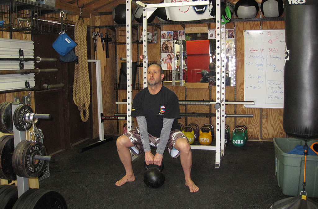 man doing a deadlift squat