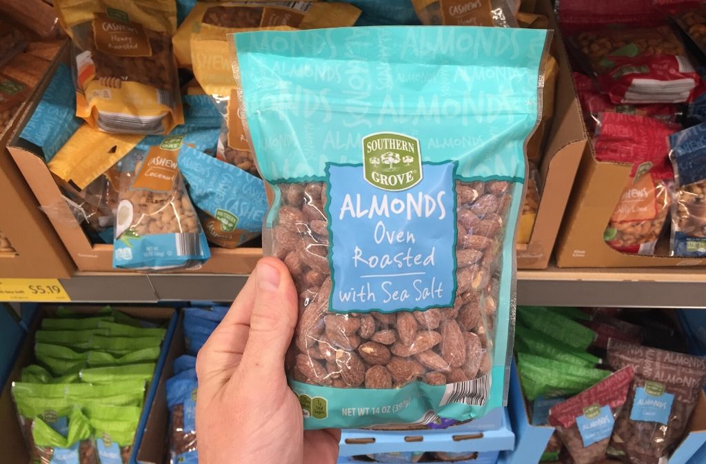 hand holding a bag of almonds