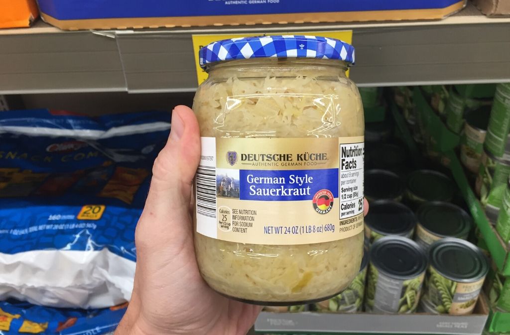 hand holding a jar of sauerkraut