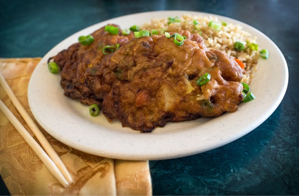 a white plate of keto friendly chinese egg foo young with rice