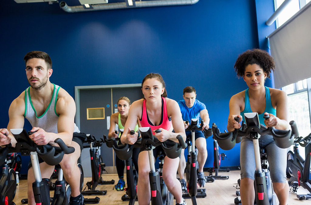 people in a spin cycling class