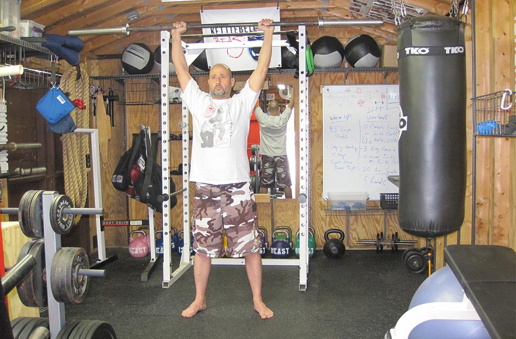 man at top of push press