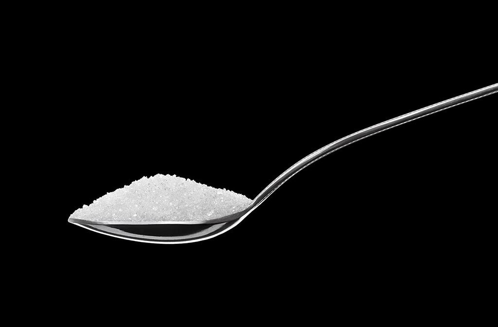 spoon of sucralose on a black background
