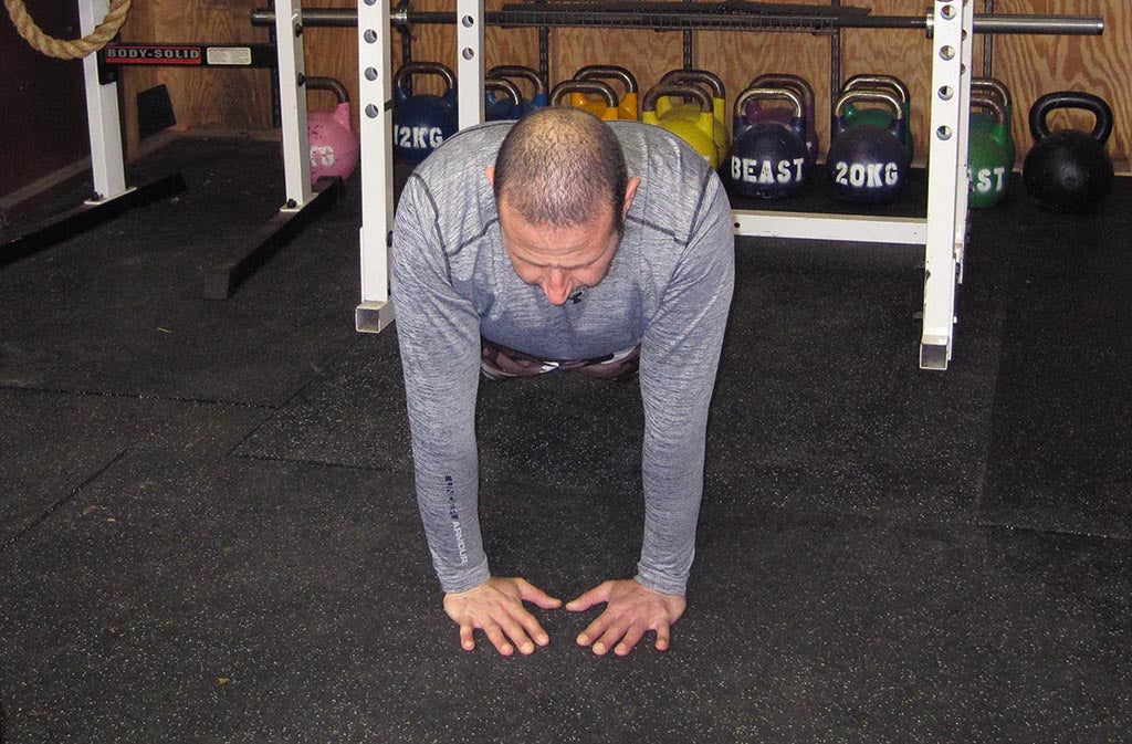 man in close grip push up position