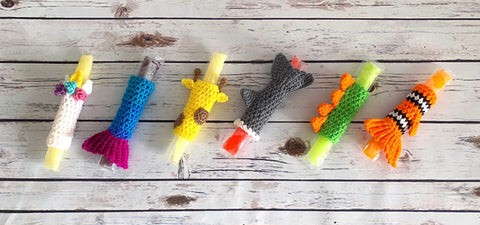 free crochet freeze pop holder pattern - 6 crochet designs for freeze pop holders shown against a wooden background