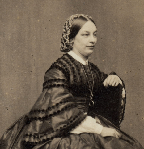 black and white photo of woman in 19th century wearing a knitted snood