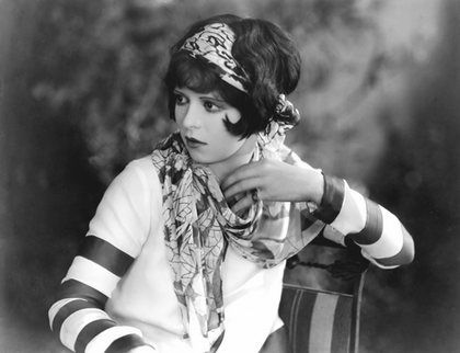 Actress Clara Bow in black and white photo with silky scarf striped sleeves and large headband