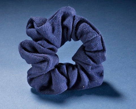 blue fabric hair scrunchie with a light blue background