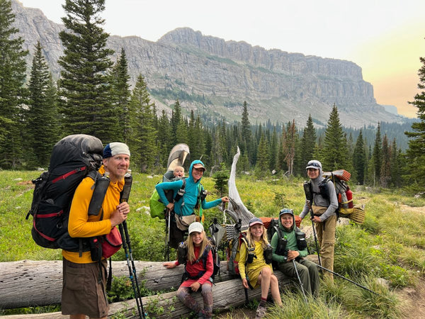 A family of 7 hiking in a gorgeous forested landscape