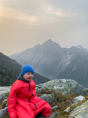 Baby in Sleeping Bag in Mountains