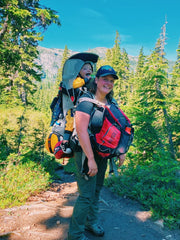 The author backpacking with her toddler in an Osprey Poco hiking carrier
