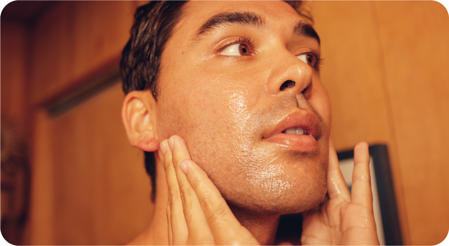 Man applying face scrub to face