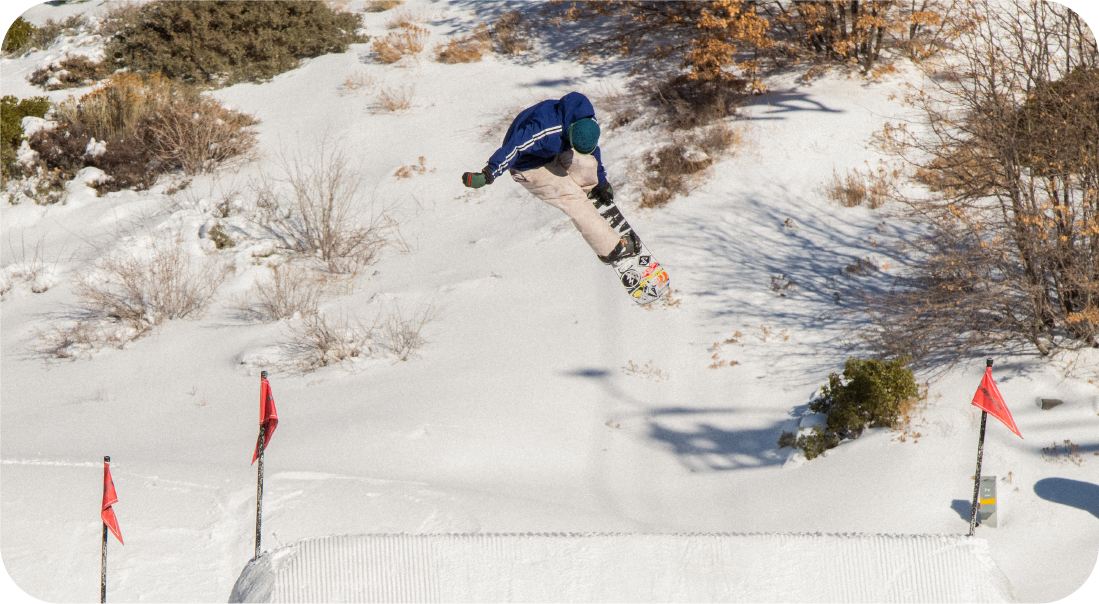 Snowboarder riding down slope