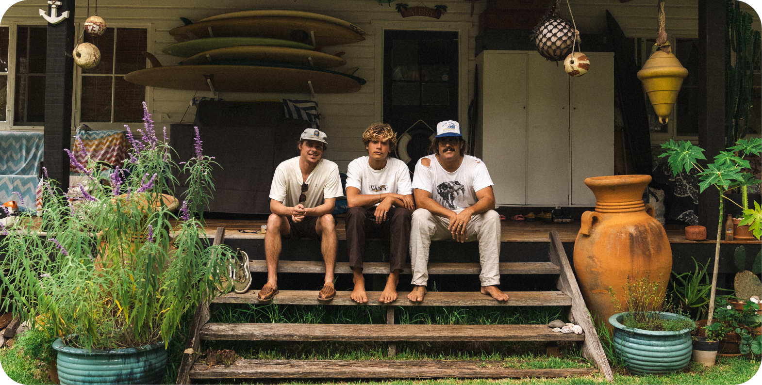 Three men sitting on a porch