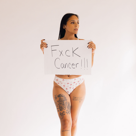 Rebecca holds a 'f#ck cancer' sign