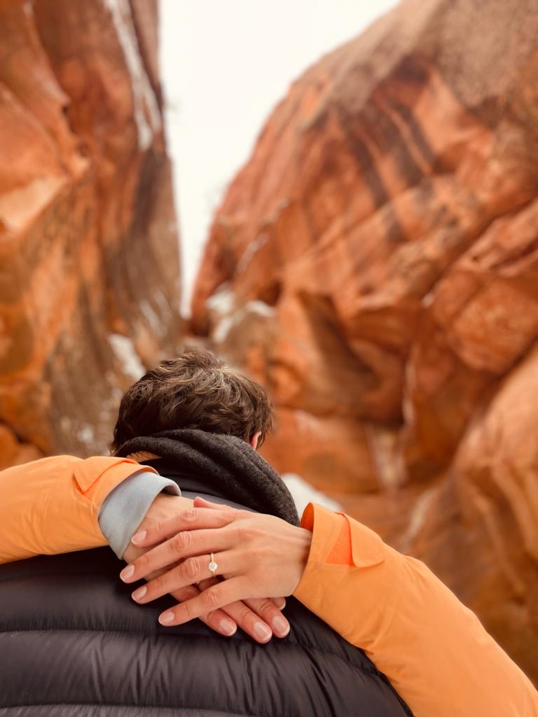 Sculpted four claw engagement ring set with white diamond on hand, surprise proposal in Zion National Park