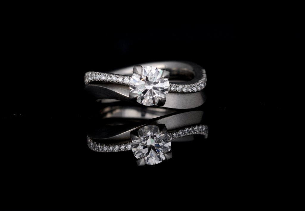 Bespoke asymmetrical fitted platinum diamond wedding band and engagement ring set