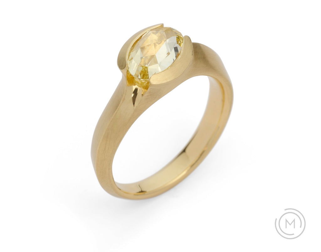 Carved gold and yellow diamond solitaire engagement ring on hand