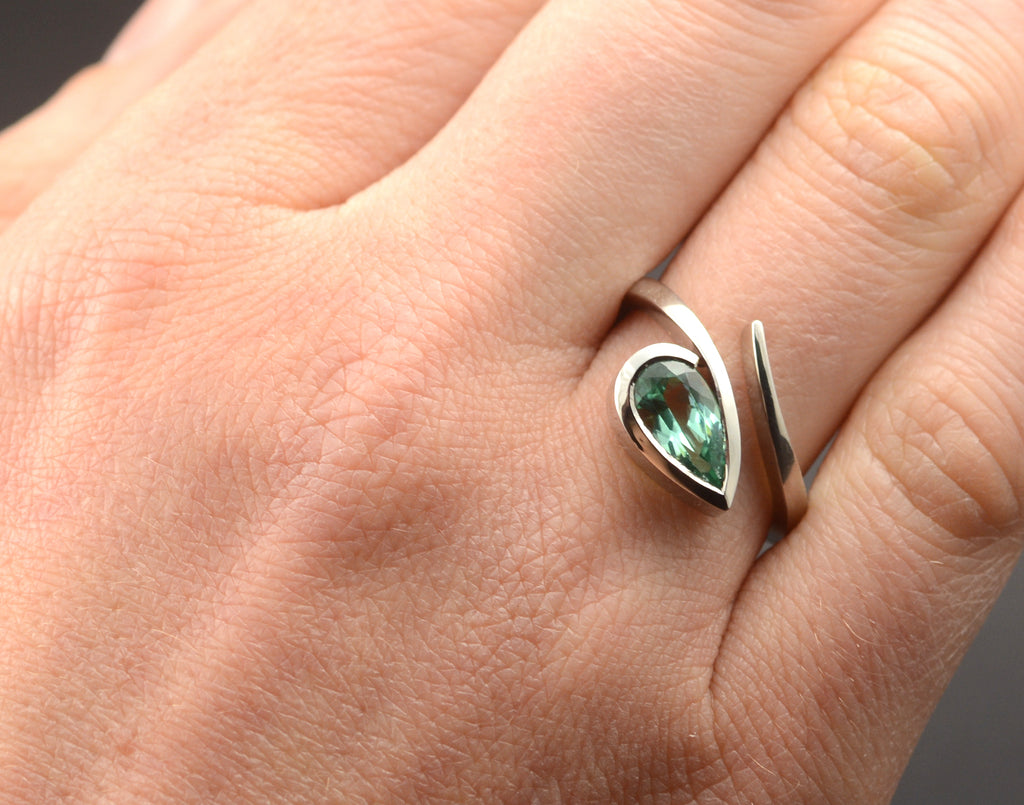 'Twist' contemporary platinum engagement ring with pear paraiba tourmaline