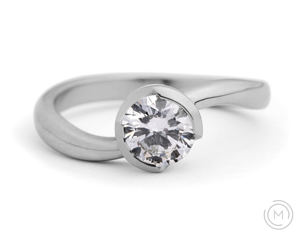 Contemporary platinum and white diamond engagement ring with curved band