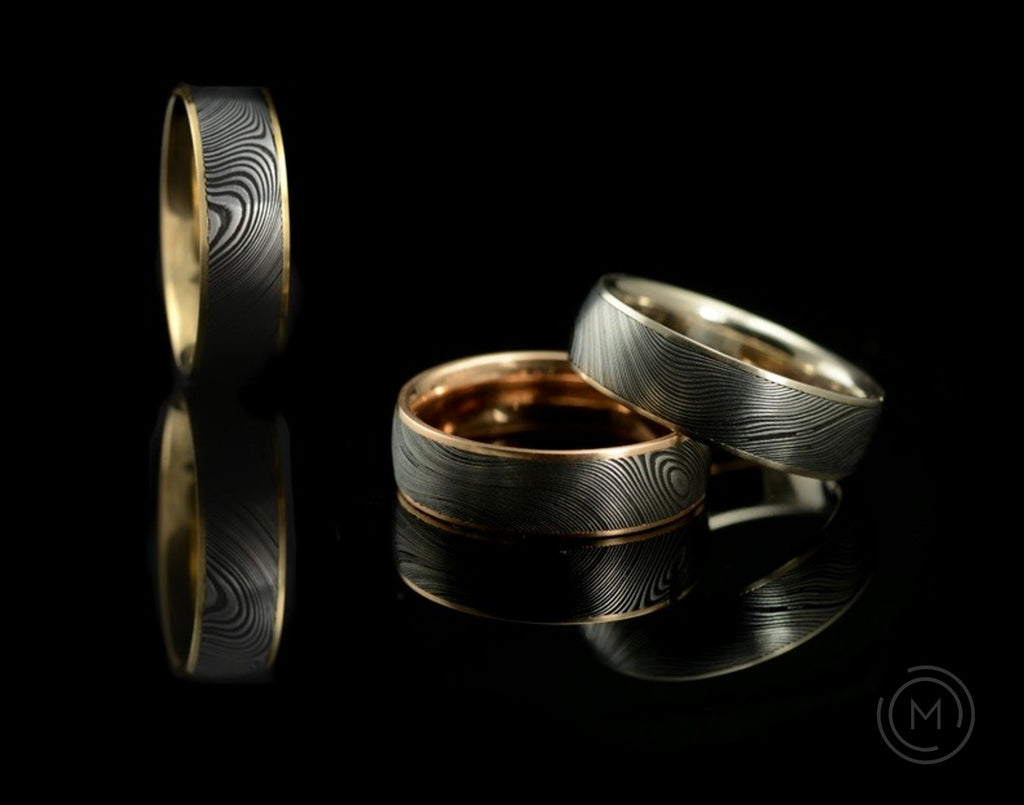 Damascus steel and 18 carat gold men's wedding rings