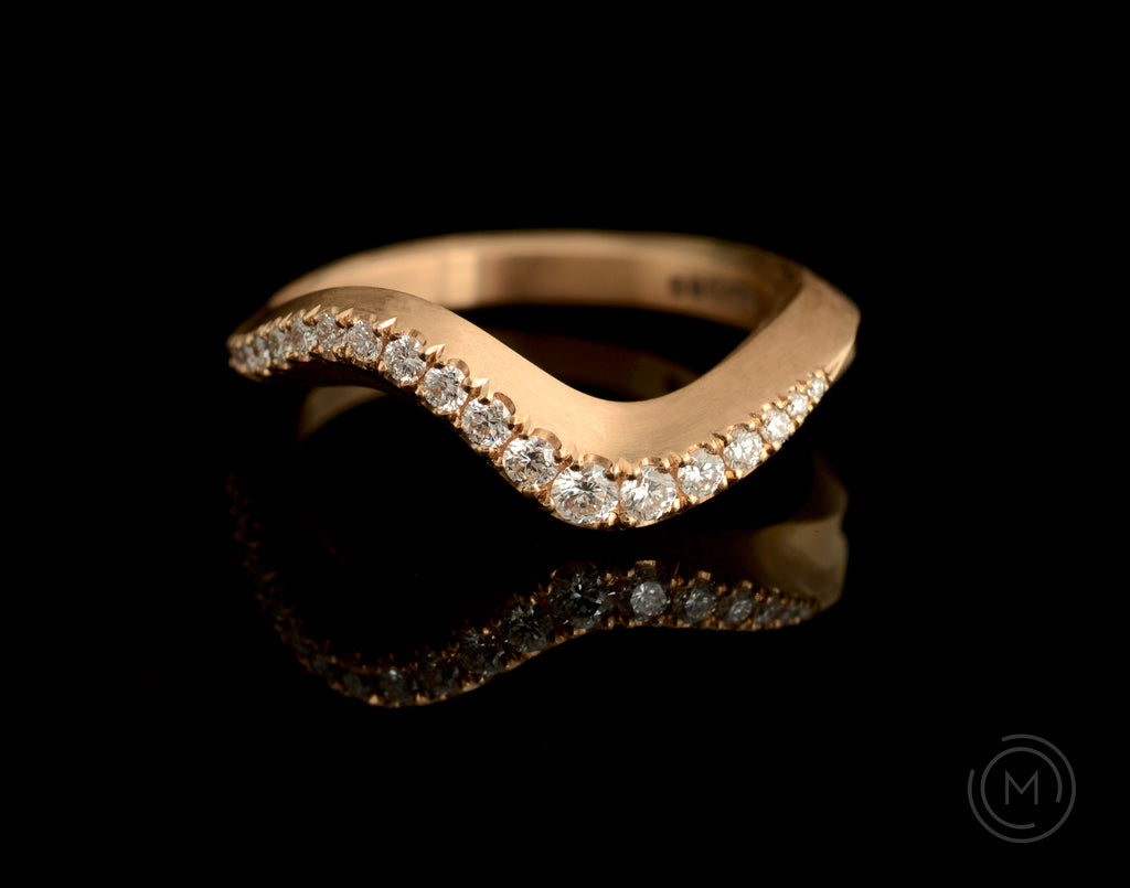 Modern rose gold engagement ring with white diamonds