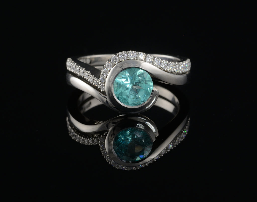 Bespoke platinum and paraiba tourmaline engagement ring with fitted diamond wedding band