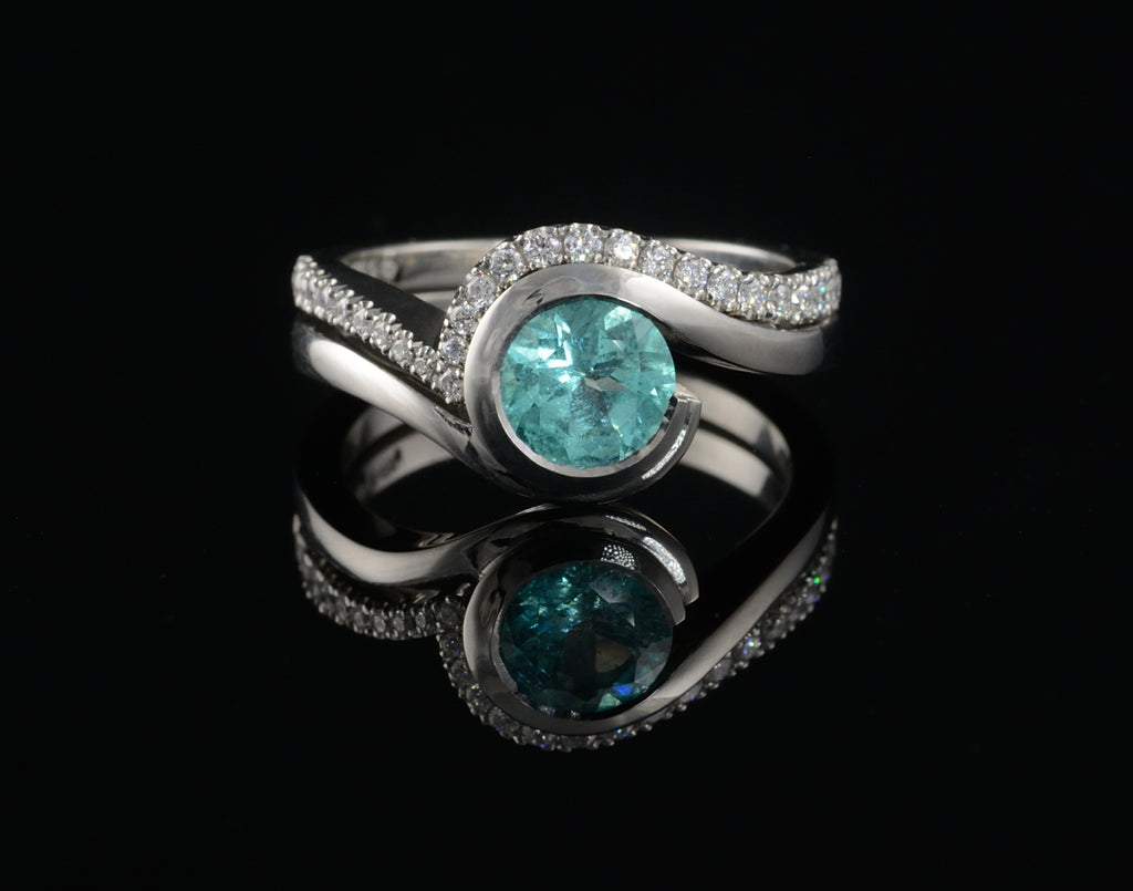 Blue paraiba tourmaline engagement ring with fitted diamond wedding band