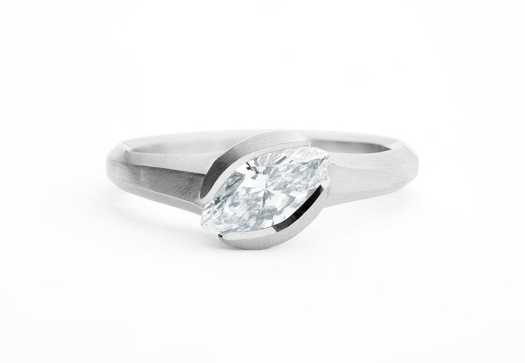 Unusual engagement ring in platinum and white marquise diamond