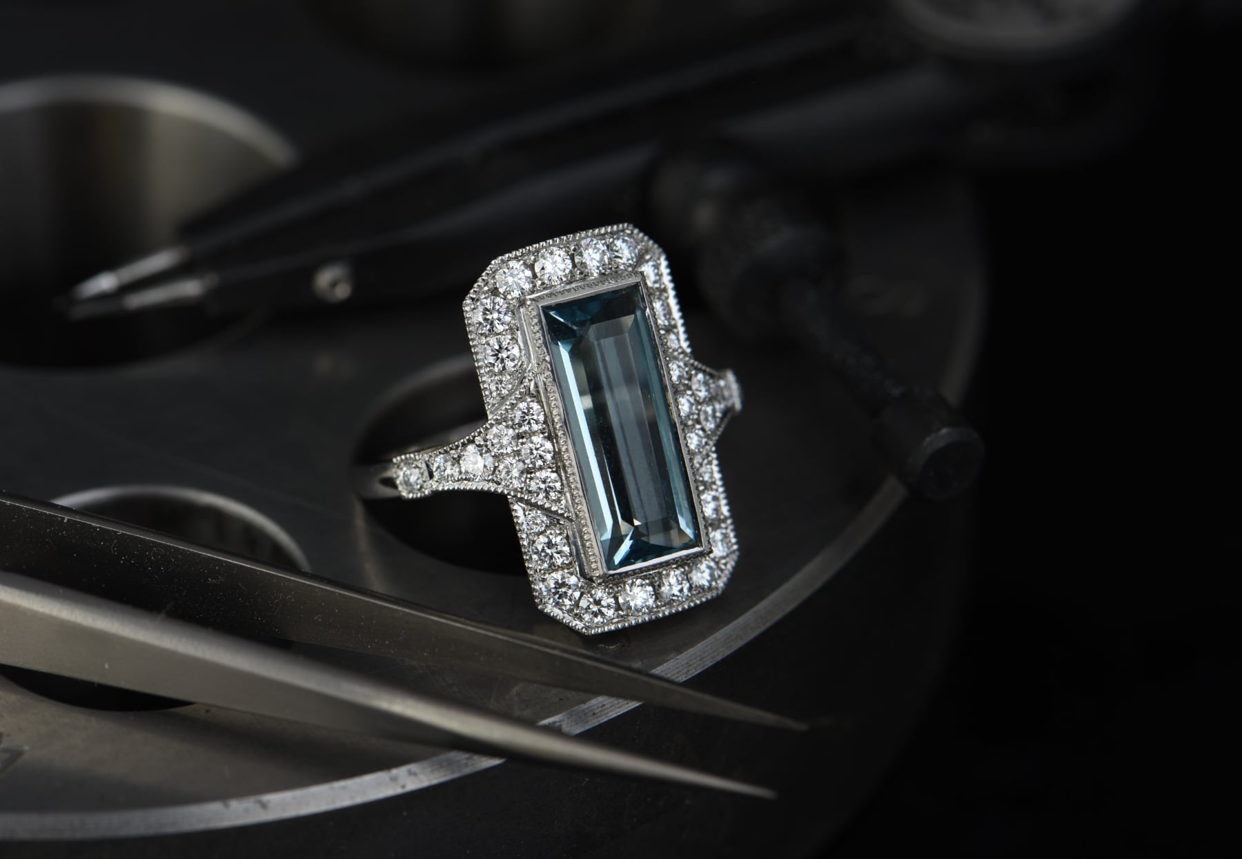 Art deco style ring with baguette shaped aquamarine and white diamond surround