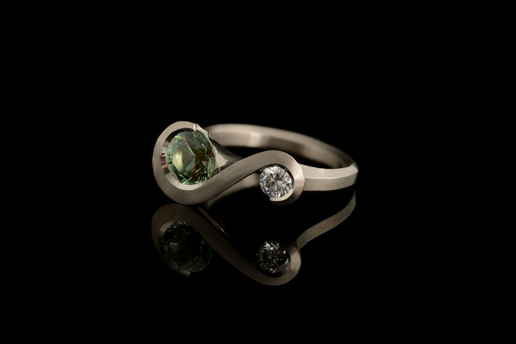 Green sapphire and white diamond zeta ring in platinum