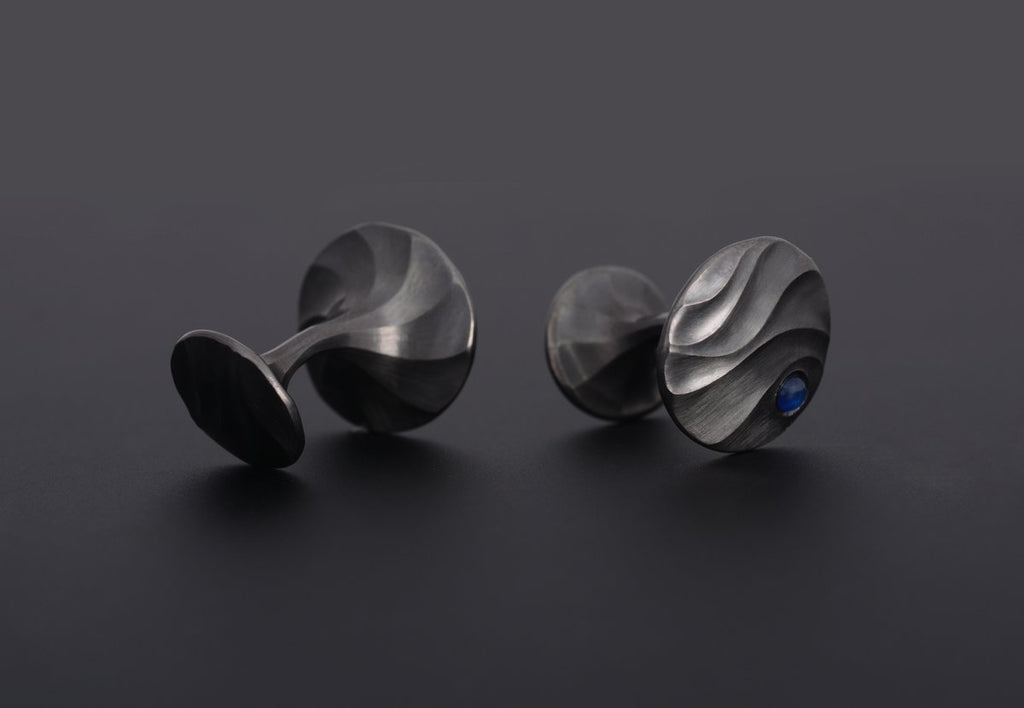 Black rhodium plated white gold carved cufflinks with blue cabochon sapphire