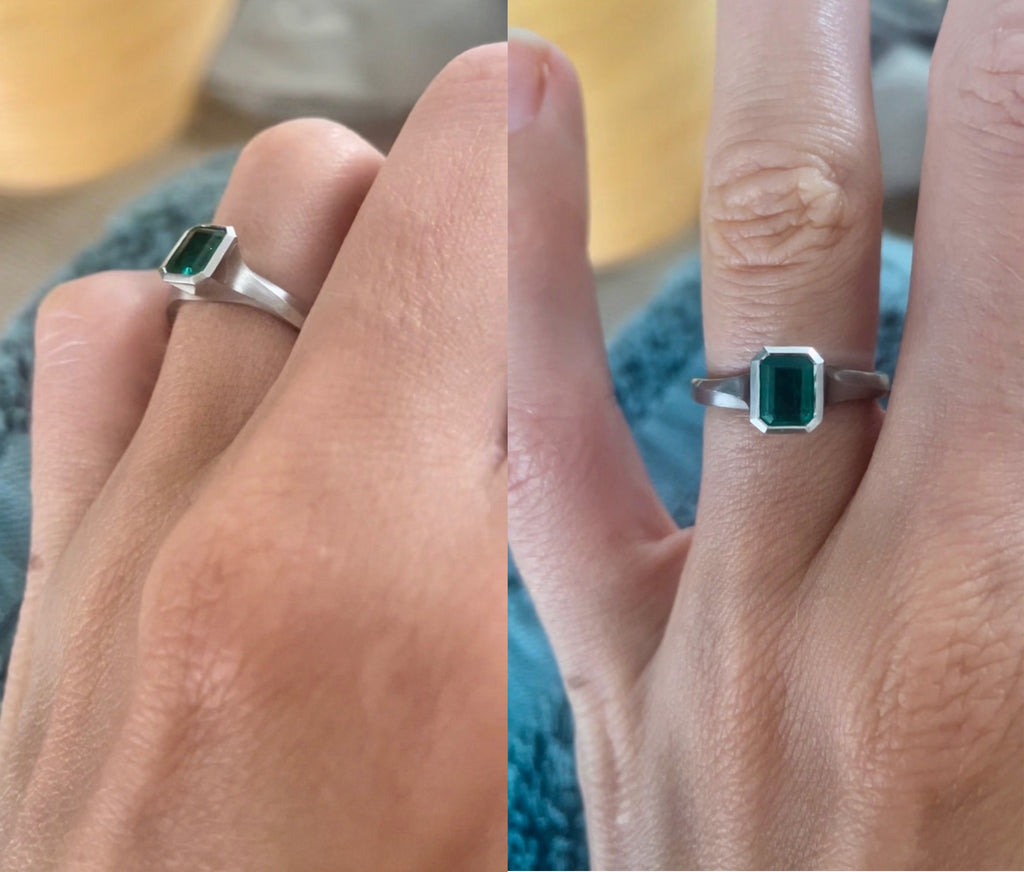 Emerald and Platinum Engagement Ring on Hand