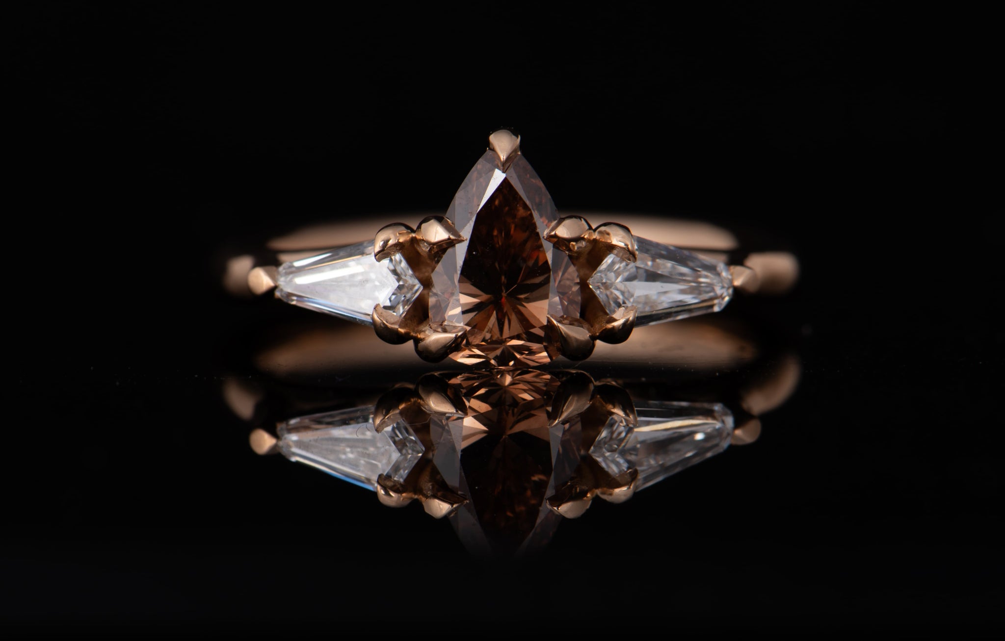 Rose gold ring with pear shape cognac diamond and shield shaped white diamonds