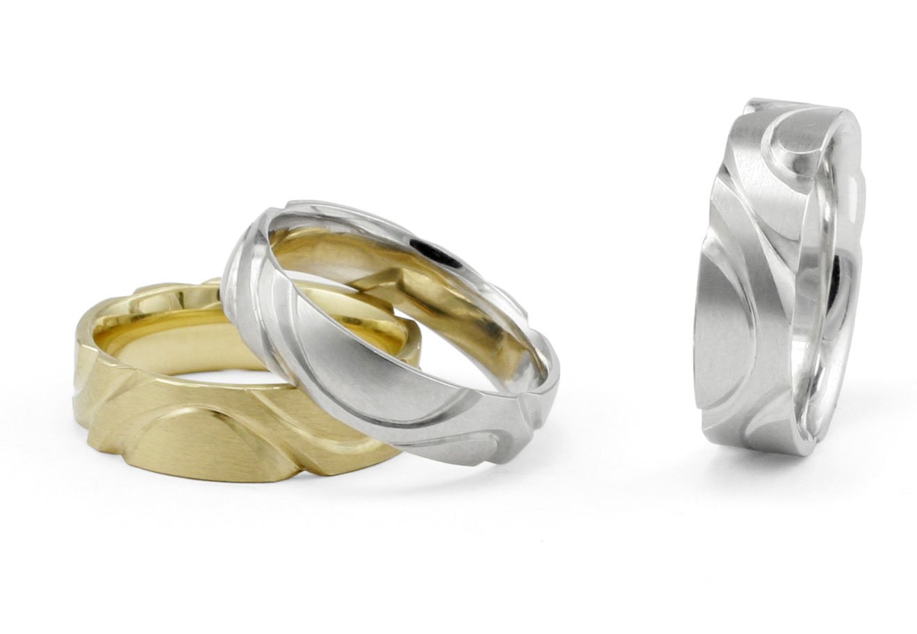 Unusual hand carved men's wedding bands in platinum and yellow gold