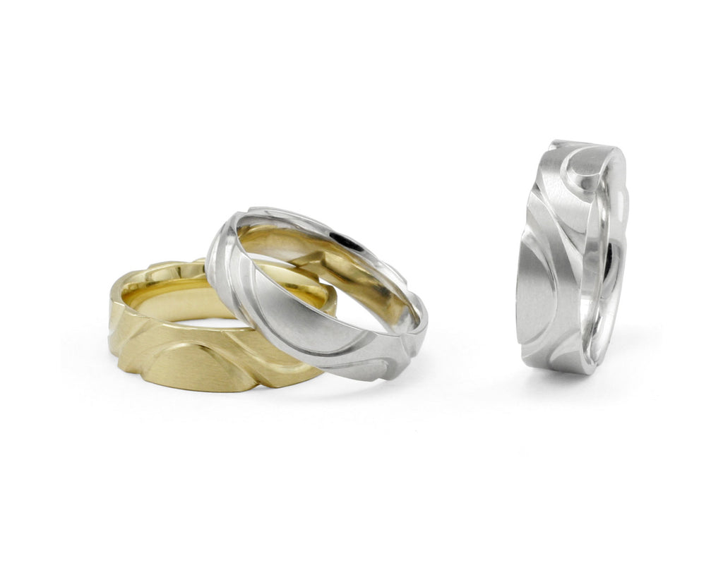 Hand-carved men's wedding rings in gold and platinum