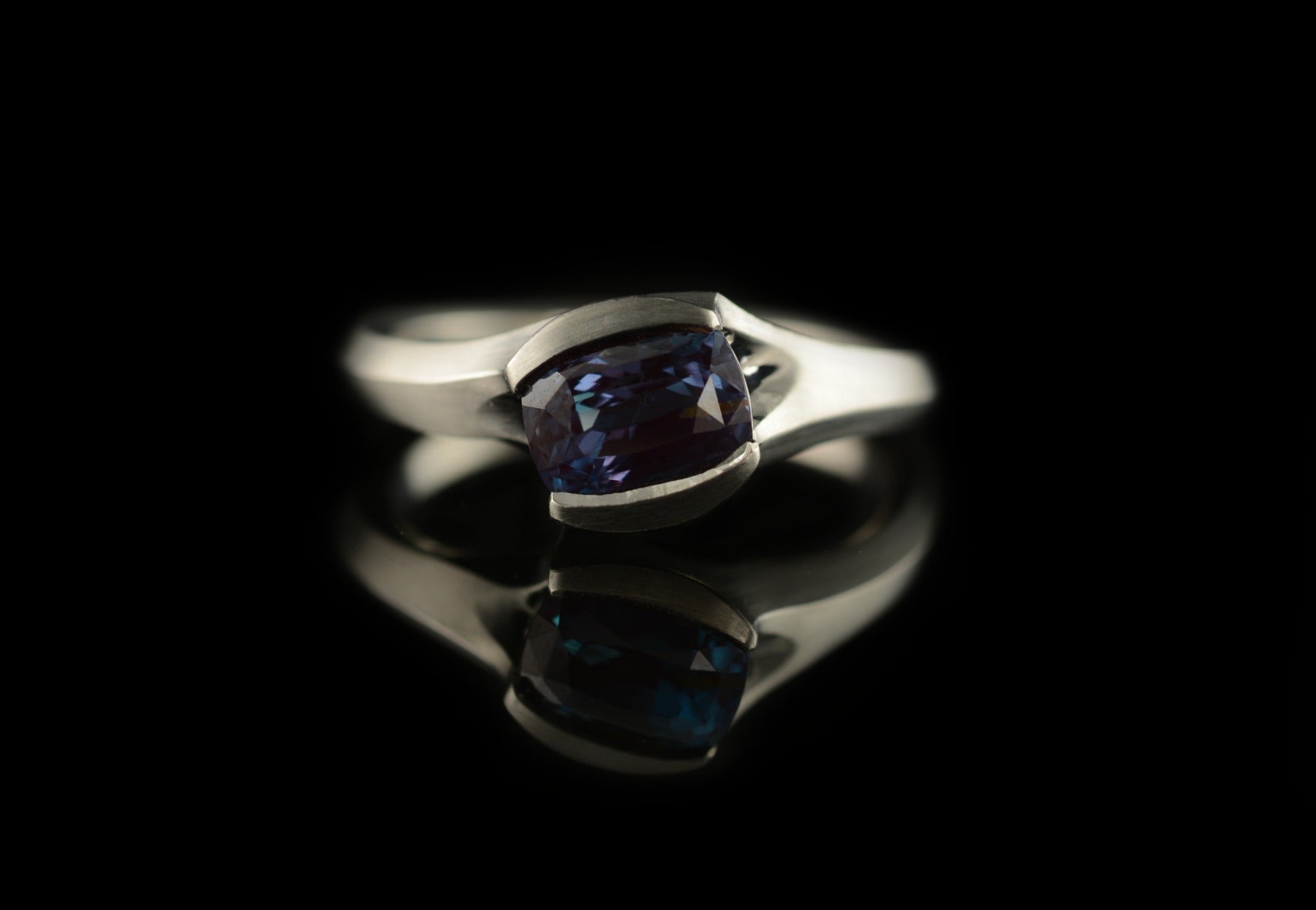 Carved platinum engagement ring with colour change alexandrite stone
