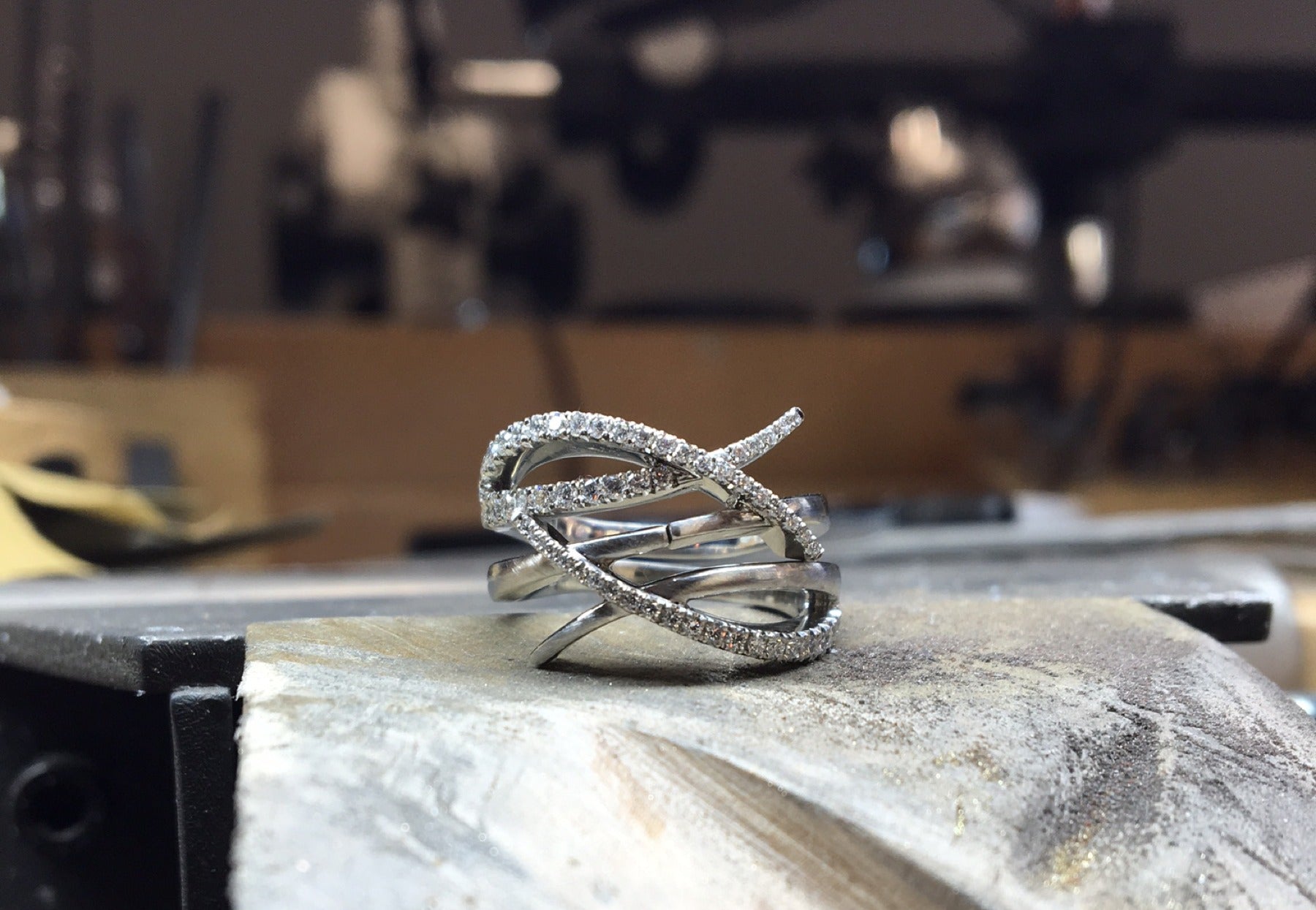 Contemporary 'Crossover' interlocking fitted wedding rings on workbench